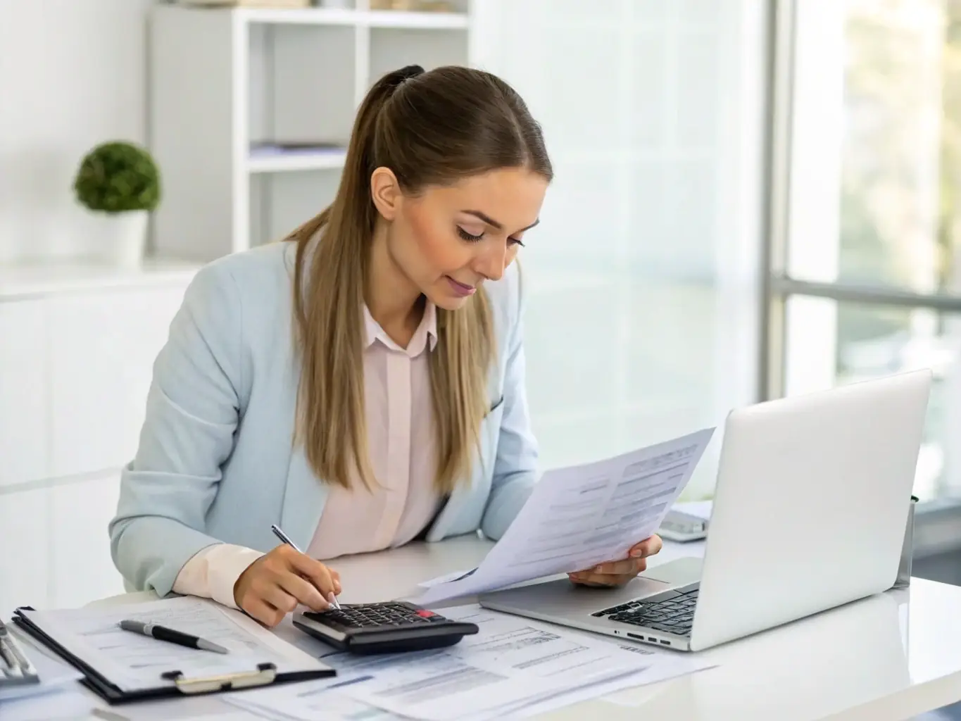 A focused professional is reviewing tax documents at a modern office, symbolizing meticulous tax planning services offered by Aanisha Advises.